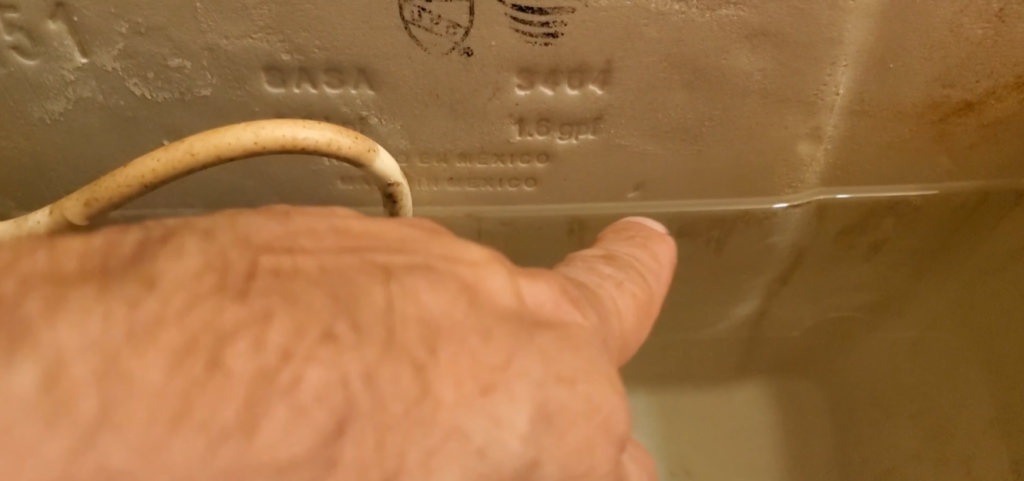 How high should the water level be in a toilet bowl